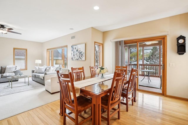 dining area with light hardwood / wood-style flooring and ceiling fan