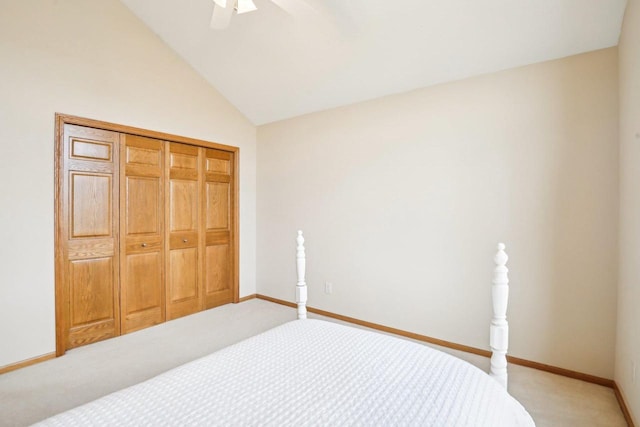 carpeted bedroom featuring vaulted ceiling, a closet, and ceiling fan