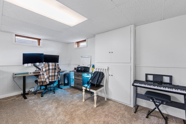 office area featuring a paneled ceiling, carpet floors, and plenty of natural light