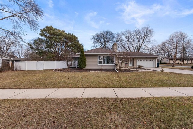 ranch-style home with a front yard and a garage