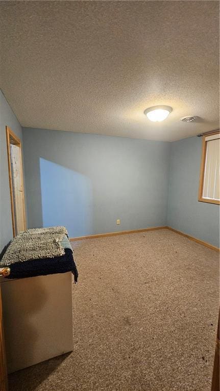 carpeted bedroom with a textured ceiling