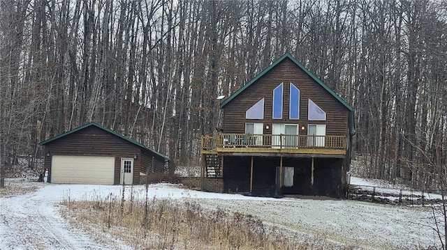 view of front of home with a garage and an outbuilding