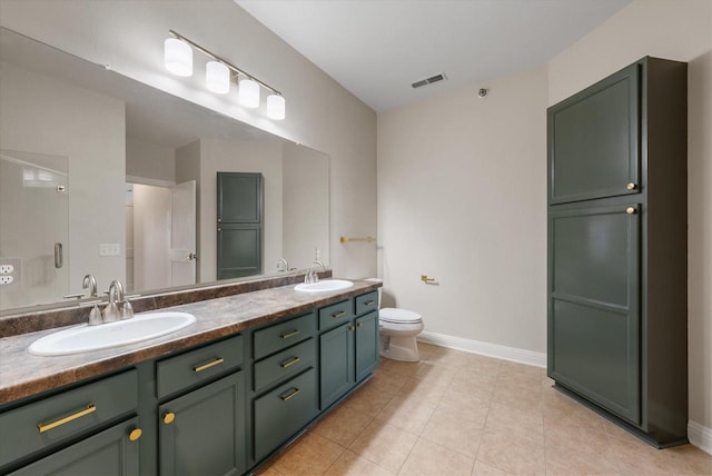 bathroom featuring tile patterned flooring, vanity, and toilet