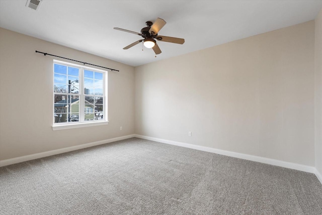 carpeted spare room featuring ceiling fan