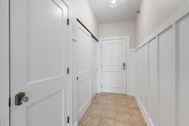 hall featuring light tile patterned flooring