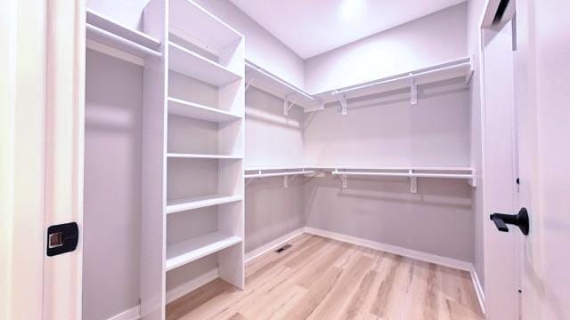 walk in closet featuring light hardwood / wood-style flooring