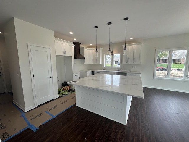 kitchen with a kitchen island, white cabinetry, dark wood-style floors, and wall chimney exhaust hood