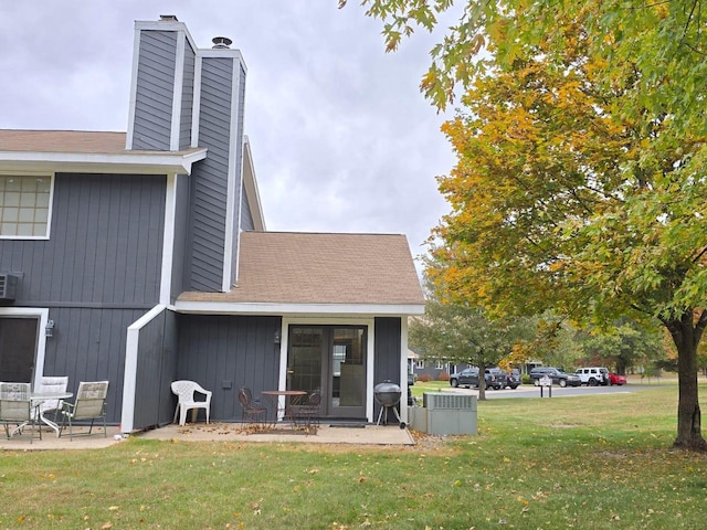 back of house featuring a yard and a patio