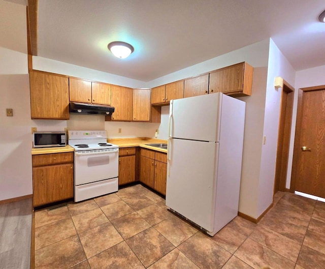 kitchen with white appliances and sink