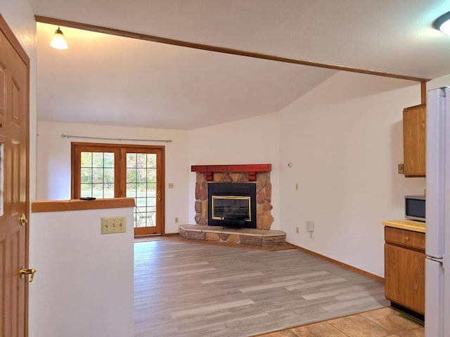 unfurnished living room featuring light wood-type flooring and a fireplace