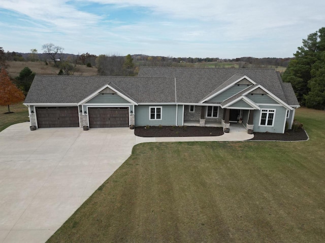 view of front of property with a front yard and a garage