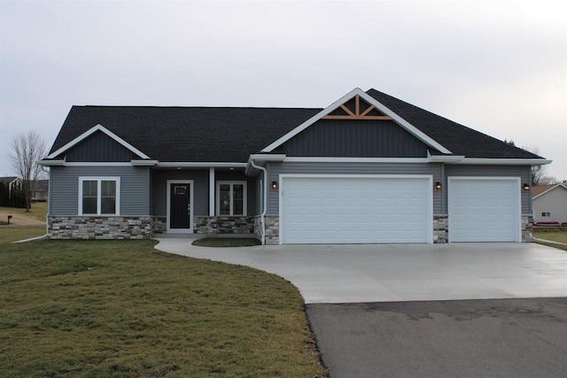 craftsman-style home featuring a front yard and a garage