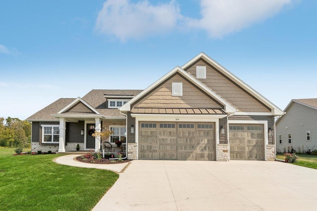 craftsman-style house featuring a front lawn and a garage