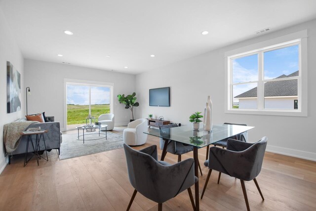 dining room with plenty of natural light and light hardwood / wood-style floors