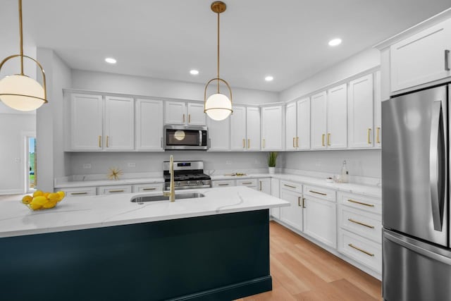 kitchen with light stone countertops, pendant lighting, and stainless steel appliances