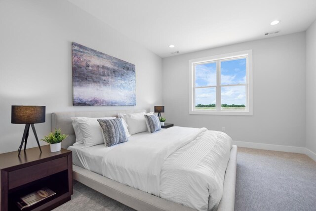 bedroom featuring light carpet