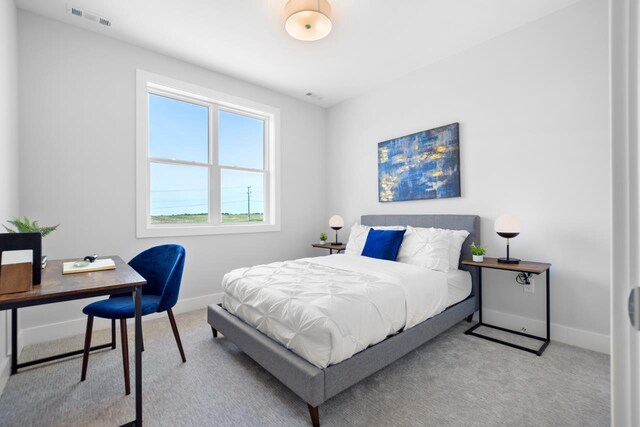 bedroom featuring light carpet