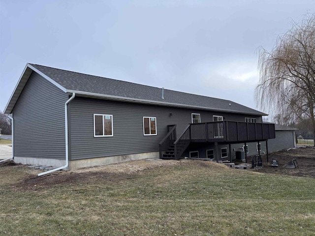 rear view of property with a lawn and a wooden deck