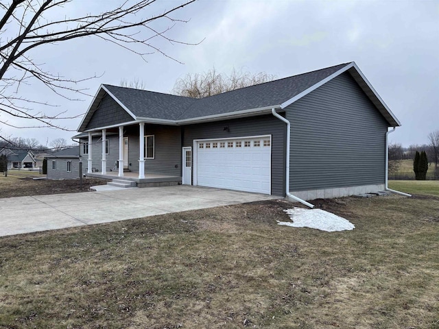 view of side of home featuring a porch, a garage, and a lawn