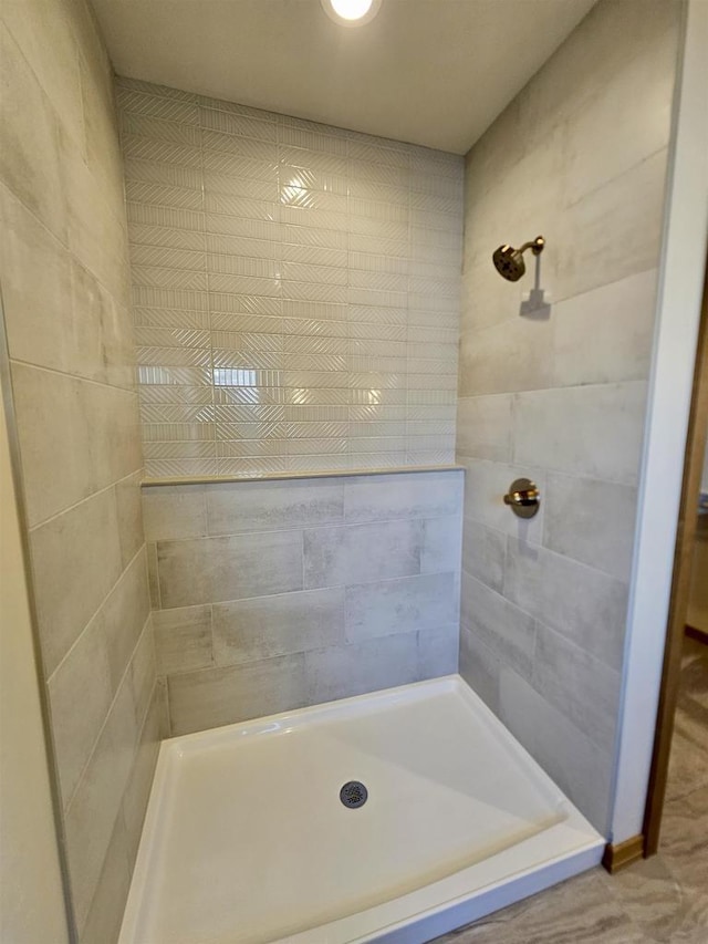 bathroom with tiled shower