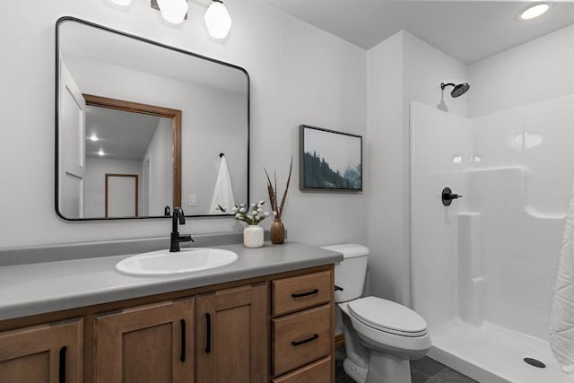 full bathroom featuring vanity, toilet, and a shower stall