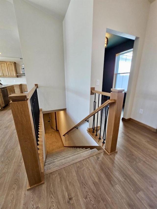 stairs featuring baseboards and wood finished floors