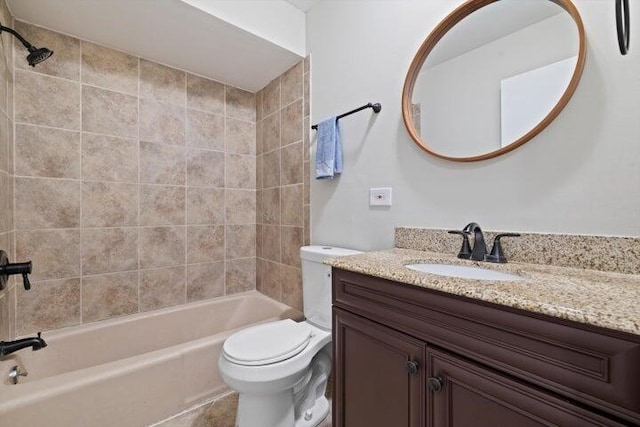 full bathroom featuring toilet, vanity, and tiled shower / bath combo