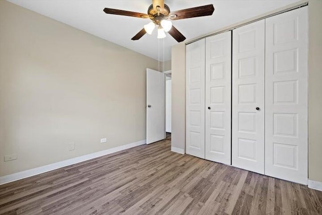 unfurnished bedroom with ceiling fan, light hardwood / wood-style floors, and a closet