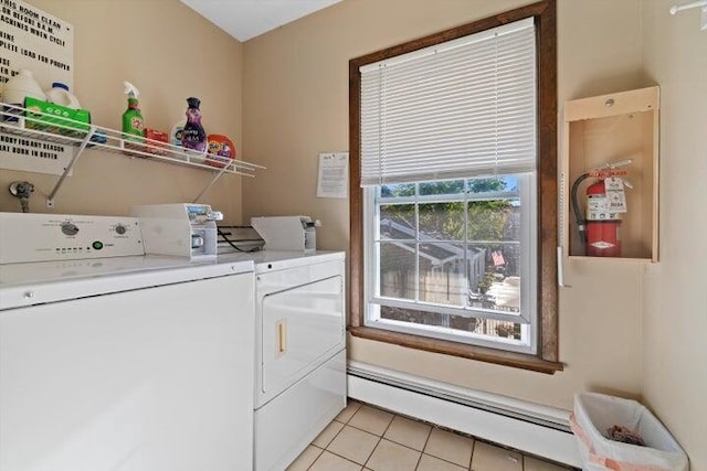 clothes washing area featuring light tile patterned floors, washer and clothes dryer, and a baseboard heating unit