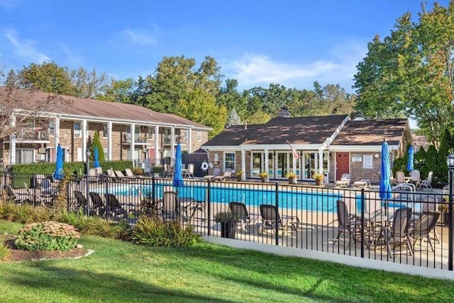 view of swimming pool with a yard and a patio