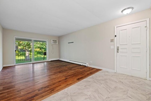 entrance foyer with light hardwood / wood-style flooring, a wall unit AC, and a baseboard heating unit