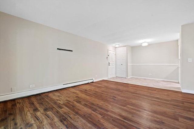 spare room with hardwood / wood-style flooring and baseboard heating