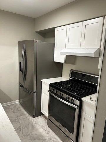 kitchen with white cabinets and appliances with stainless steel finishes