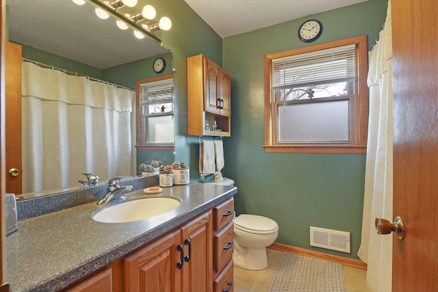 bathroom with vanity, a healthy amount of sunlight, and toilet