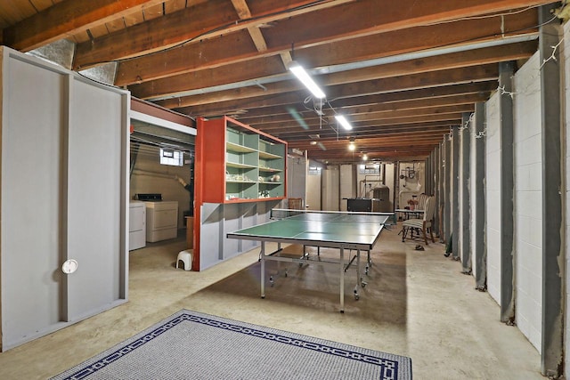 game room featuring concrete floors and separate washer and dryer