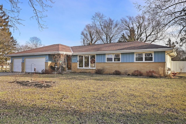 single story home with a front yard and a garage