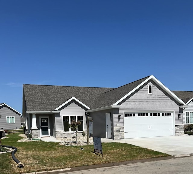 view of front of home with a garage and a front lawn