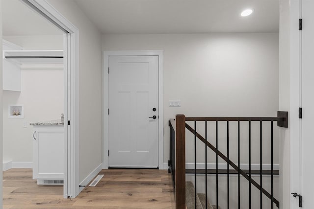 corridor with hardwood / wood-style floors