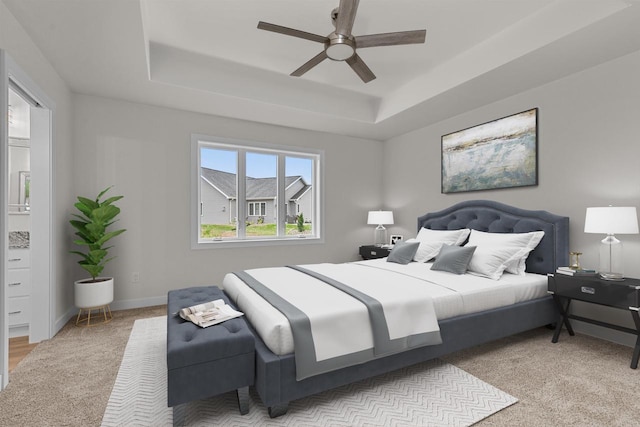 carpeted bedroom with ceiling fan and a raised ceiling