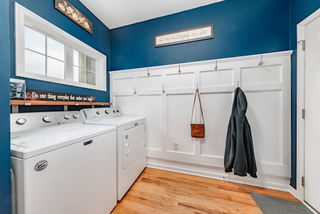 laundry room with light hardwood / wood-style flooring and independent washer and dryer