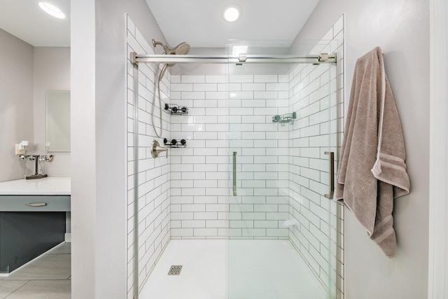 bathroom featuring vanity and an enclosed shower