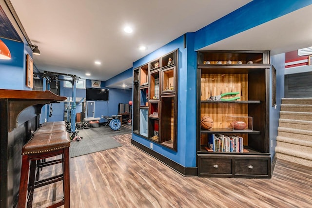 bar with hardwood / wood-style floors