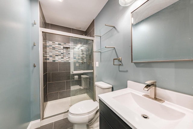 bathroom with vanity, an enclosed shower, and toilet