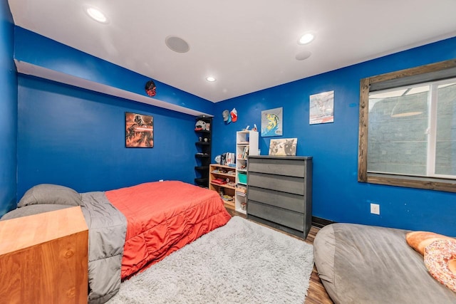 bedroom with hardwood / wood-style flooring