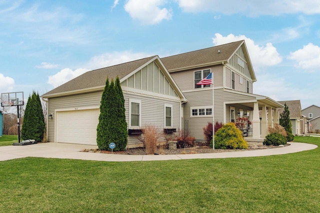 view of front of home featuring a front yard, a porch, and a garage