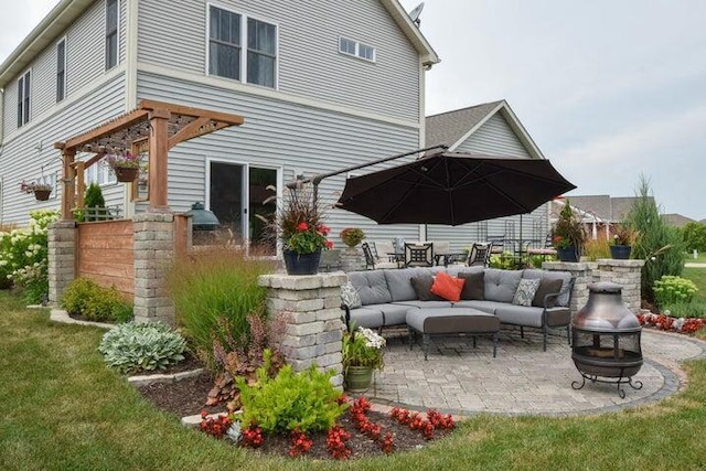 view of patio with an outdoor living space with a fire pit