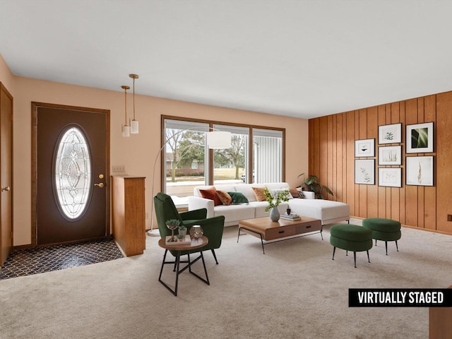 carpeted living room featuring plenty of natural light and wood walls