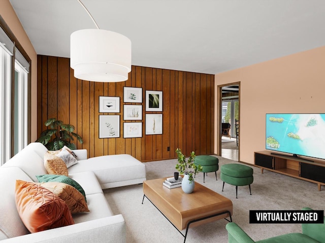 carpeted living room with wooden walls