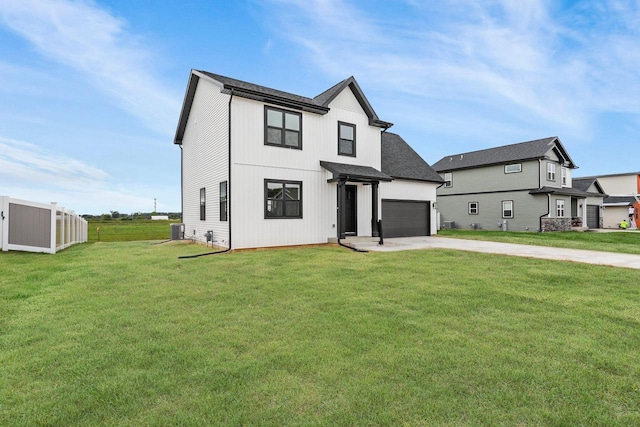 view of front of house with a garage, a front lawn, and cooling unit