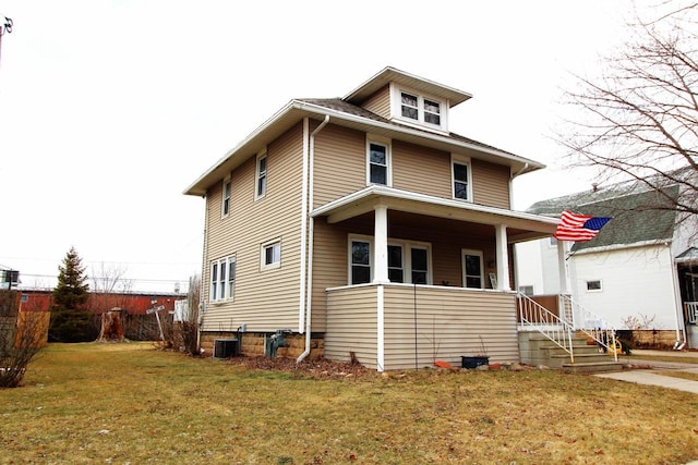 view of front of home with central AC unit and a front yard